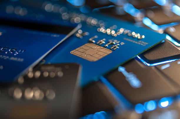 Identity theft involving credit cards on a keyboard background highlights financial fraud risks.