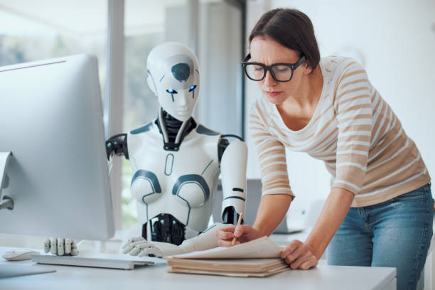 AI robot assisting a woman in an office, both focused on work tasks.